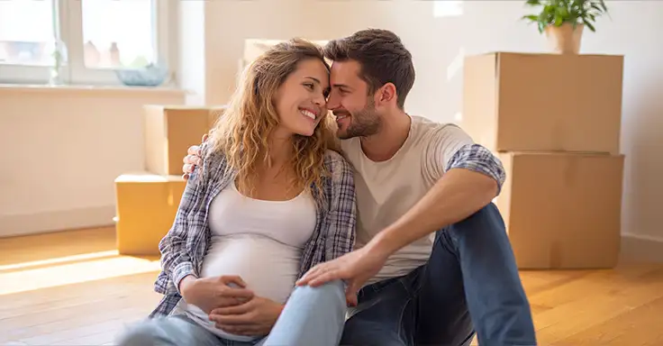 Lächelndes Paar mit Umzugskartons in neuer Wohnung